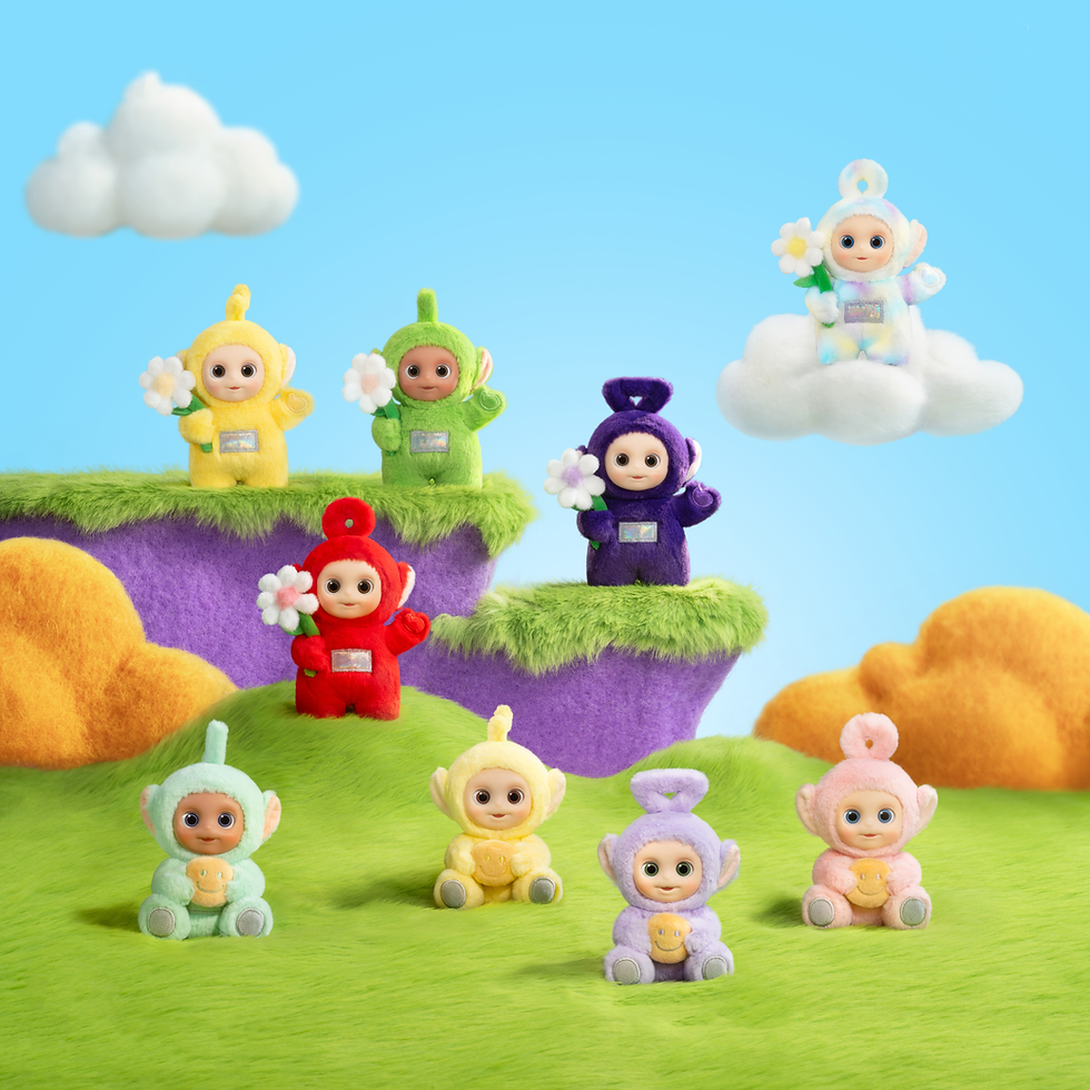 A product shot of small toys as colourful creatures sitting on clouds and in a bright field.