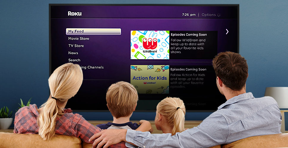 a family looks at the Roku guide on their television