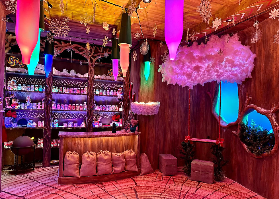 A wooden room lit with giant Christmas lights and decorated with snowflakes.