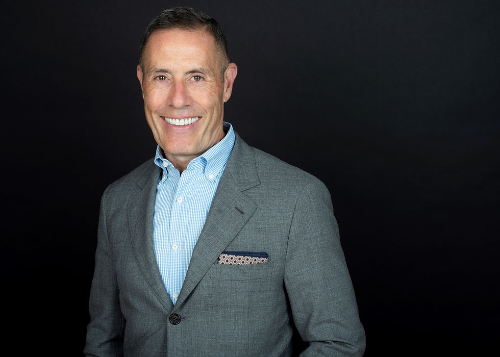 a portrait of a smiling man in a suit