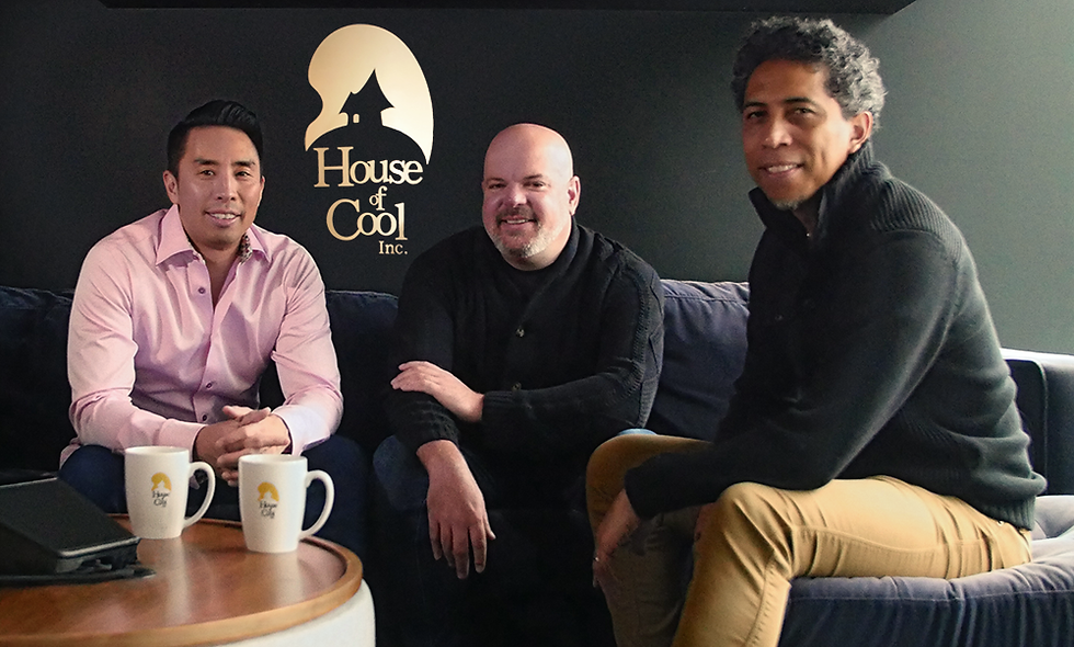 three men sitting on a sofa