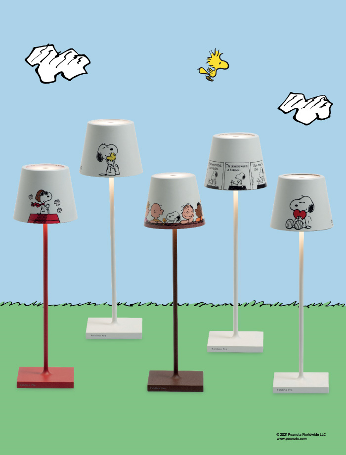 five standing floor lamps agaist a cartoon background of a green field and blue sky with small white clods a a little yellow bird