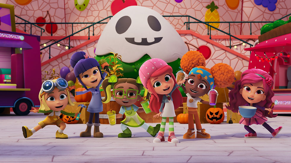 A group of CG-animated fruit-themed girls stand in front of Halloween decorations, holding drinks and smiling.