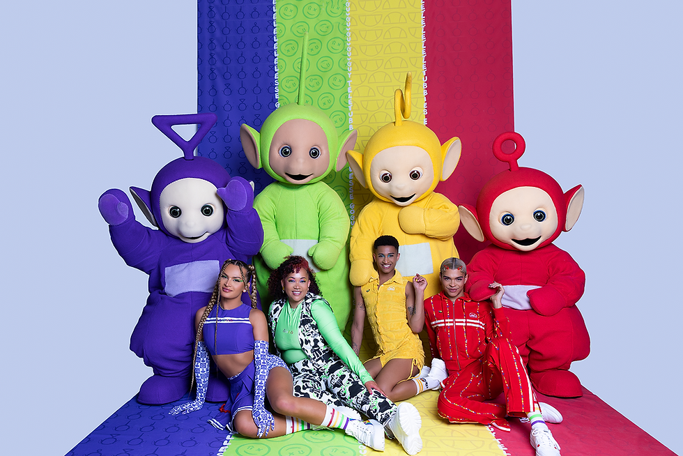 Four people posing with four costumed alien characters. Each of their outfits matches one of the characters.