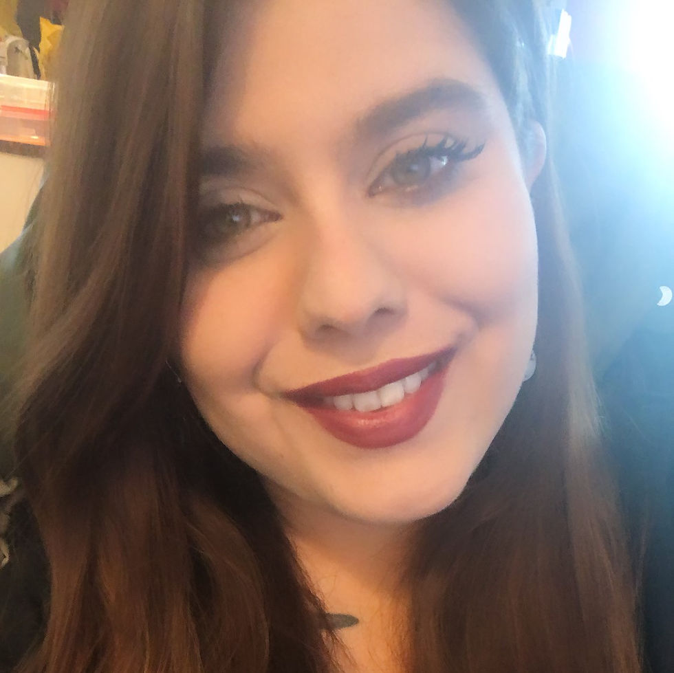 close up of a brown haired person posing for a photo