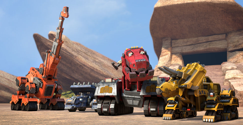 4 trucks that look like dinosaurs in a rocky area