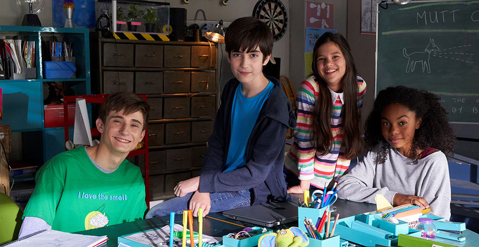 two boys and two girls in a garage they've turned into an office