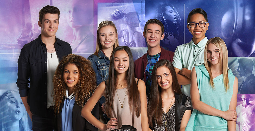 a group of students posing in front of a colourful background
