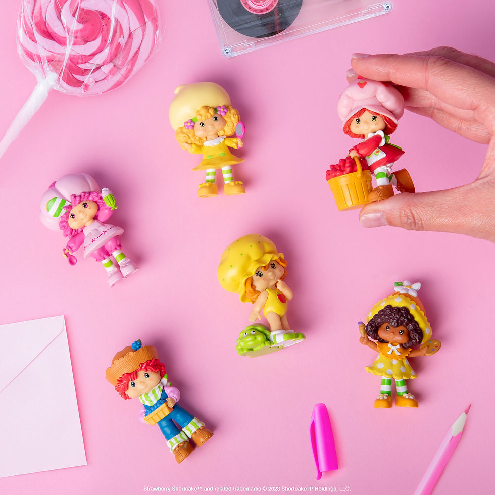 6 small plastic dolls of the main characters from Strawberry Shortcake