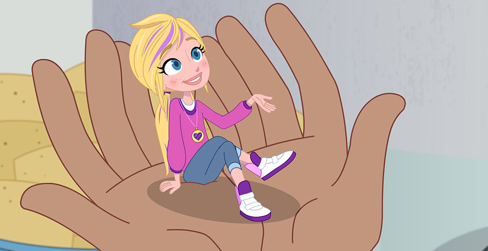 a tiny girl sitting in the hands of someone else