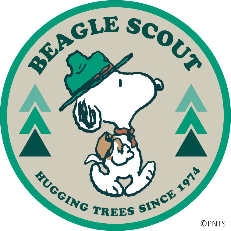 a dog wearing a green hat and backpack. "Beagle Scout, hugging trees since 1974"