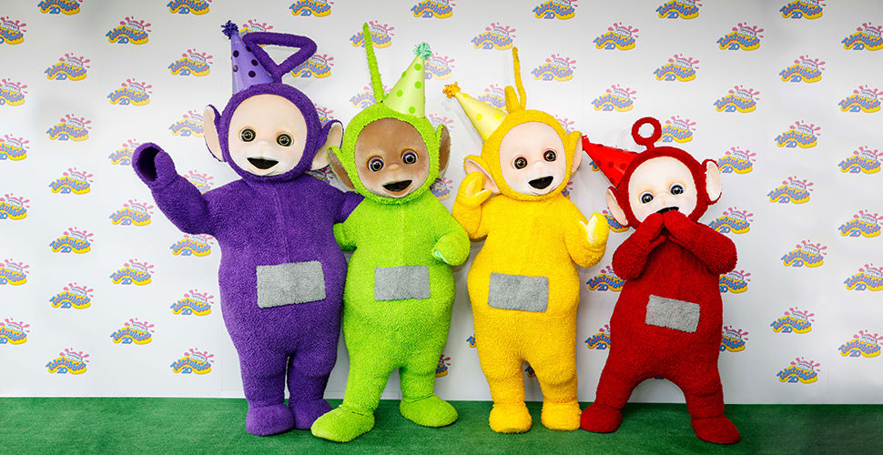 4 fuzzy creatures wearing party hats - purple, green, yellow, red