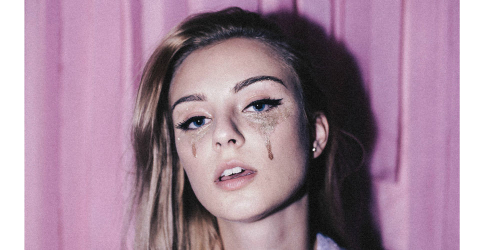 young woman with glitter makeup to make it look like she is crying