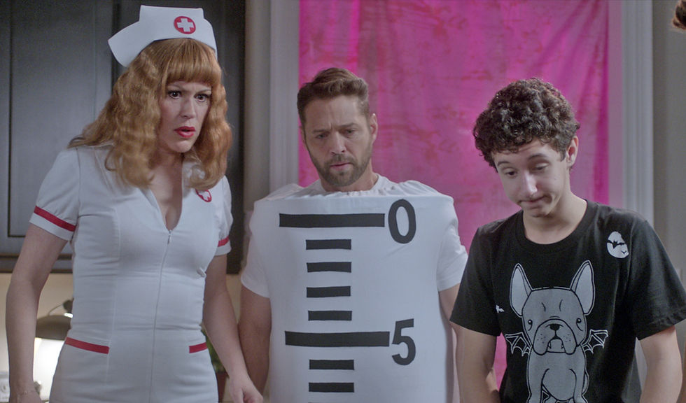 woman in a nurse costume, man in a graduated cylinder costume, and boy in a t-shirt