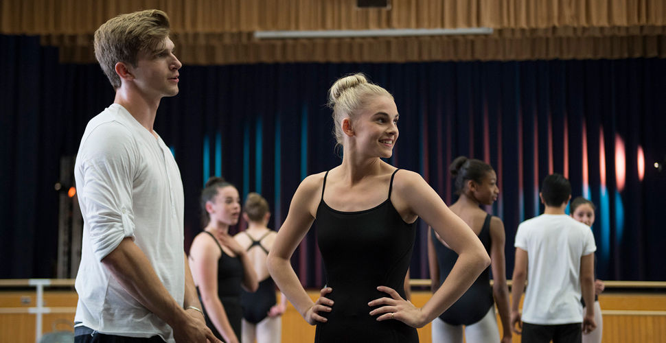 two dance students in front of a group in a studio