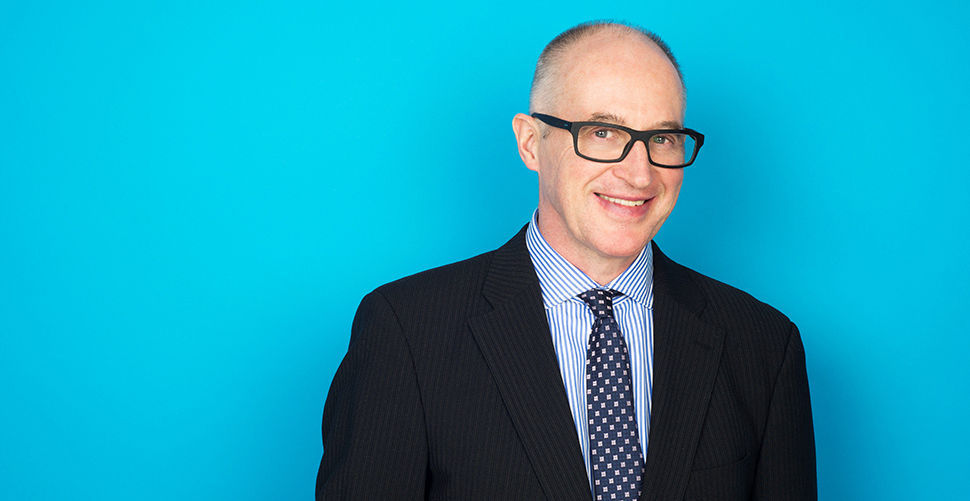 a man in glasses and a suit and tie